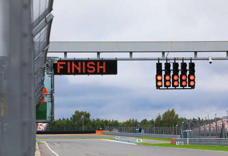 Finishing line with the finish on the electronic display and the red lights on the race trackの写真素材