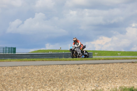 MOSCOW, RUSSIA - JULY 21, 2019: Racing bike rider in helmet racing at high speed on race track...