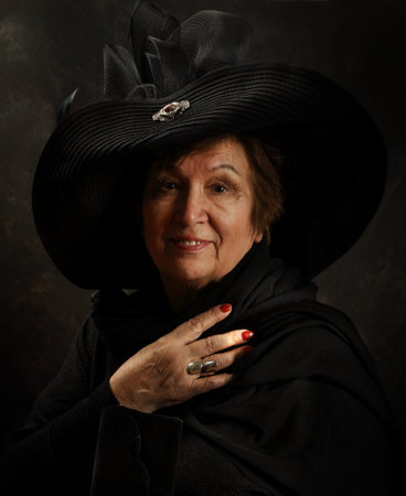 Portrait of an elderly lady in the Victorian style in the studio on an artistic background