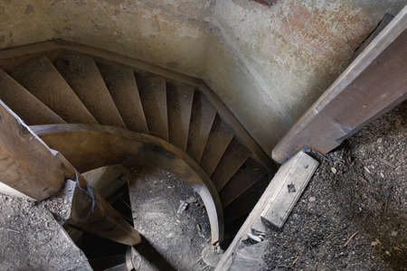 Detail of the interior with a spiral staircase in an old abandoned houseの写真素材