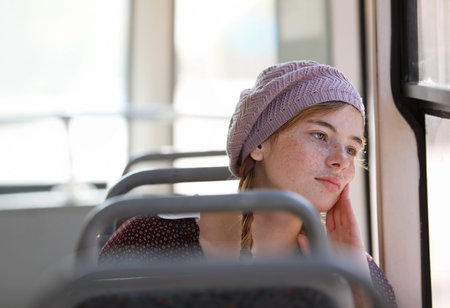 Portrait of a young nice freckled girl with pigtails dressed in retro style clothes in a wagon of a...