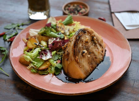 Cabbage steak with mixed salad served with vegetable smoothie on a wooden tableの写真素材