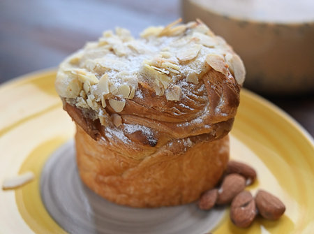 Close-up tasty almond cake on the wooden cafe table