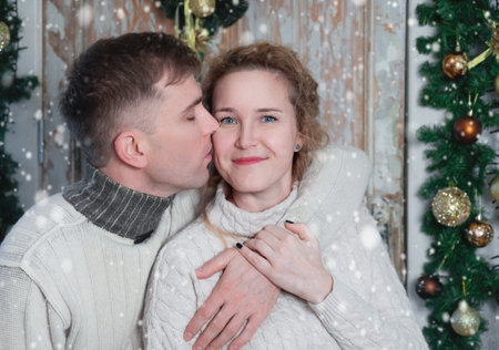Christmas, relationship and love. A lovely couple in romantic moments at home together.の写真素材