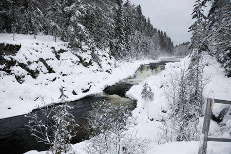 View of Kivach waterfall in the winter forest in Karelia, Russiaの写真素材