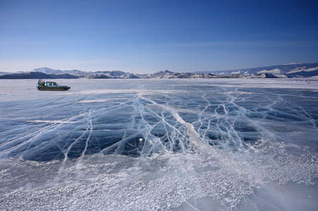 Hovercraft on frozen icy surface of the Baikal lake near Olkhon Island, Russia. Clear winter weatherの写真素材