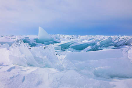 Huge ridge of ice hummocks covered with snow after powerful winter storm and ice pressure on Lake Baikal, Russiaの写真素材