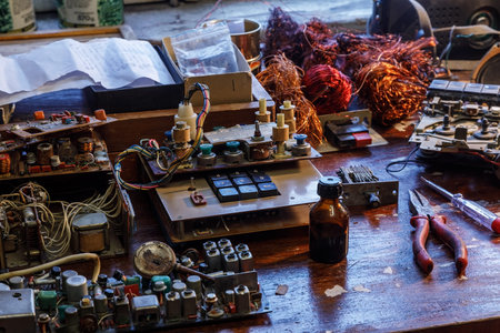 Radio parts and tools lying in disarray on a wooden table