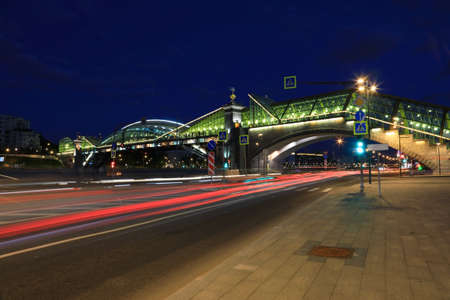 Night city landscape with a view of pedestrian Bogdan Khmelnitsky Bridge over the Moscow River, Russiaの写真素材