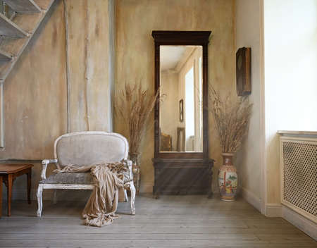 Vintage studio apartment interior in light colors in old style, living room with large windows and a couchの写真素材