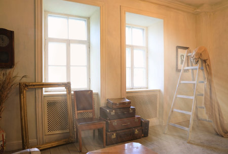 The interior of the living room is in a vintage style with large windows flooded with sunlightの写真素材