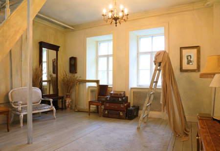 Interior of the living room is in a retro style with large windows flooded with sunlightの写真素材