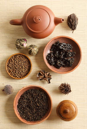 Set of different types of tea with a tea kettle on the tableの写真素材