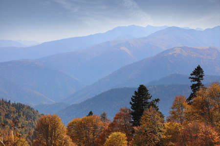 Amazing mountain range in the blue haze of an early autumn morning. Caucasus mountains in Adygea, Russiaの写真素材