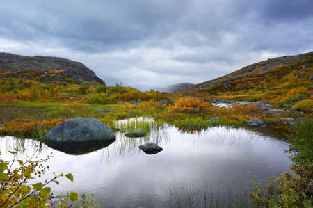 Fantastic landscape with lakes and mountains of wild nature in autumn on the Kola Peninsula in northern Russiaの写真素材