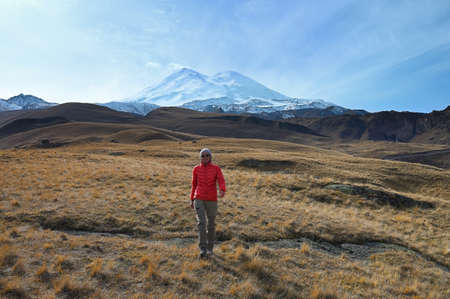 Tourist girl walks near Mount Elbrus in Russiaの写真素材