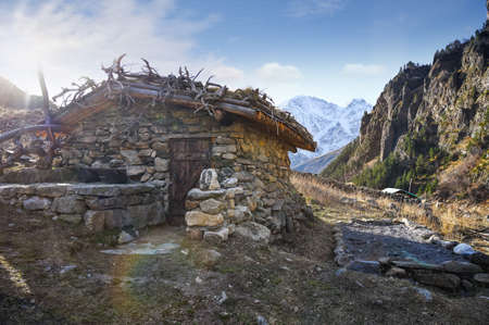 Hunter's stone hut in the Elbrus region in the Caucasus Mountains on an early sunny morning in autumn, Russiaの写真素材