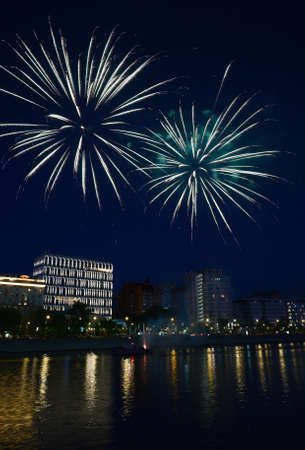 Evening colorful festival fireworks at the riverの写真素材