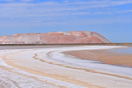 Toxic lakes and waste hills  in the production of potash fertilizers and salt against the blue skyの写真素材