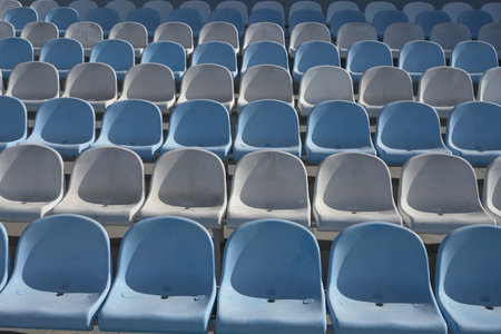 Empty blue and white seats of an open air sports facility