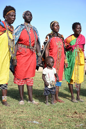 MAASAI MARA NATIONAL RESERVE, KENYA, AFRICA - NOVEMBER 11, 2022: People of Kenya. Maasai women in traditional clothes and outfits singing a wedding song in a Maasai village in Kenya, Africaのeditorial素材