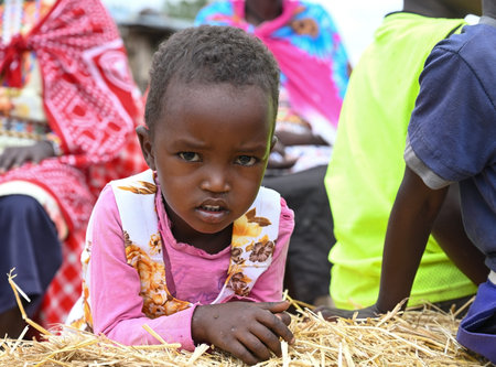 VILLAGE NEAR NAIROBI, KENYA - NOVEMBER 14, 2022:  Portrait of an African girl from Masai tribe, Kenya, Africaのeditorial素材
