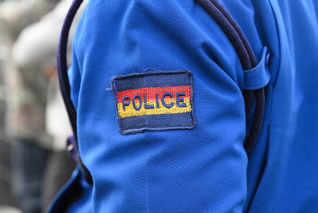 The chevron "Police" on the sleeve of a blue police suit in Nairobi. Kenya, Africaの写真素材