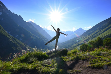 Young woman poses against the backdrop of beautiful mountains in the background lightingの写真素材