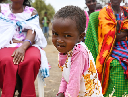 VILLAGE NEAR NAIROBI, KENYA - NOVEMBER 14, 2022:  Portrait of an African little girl from Masai tribe, Kenya, Africaのeditorial素材