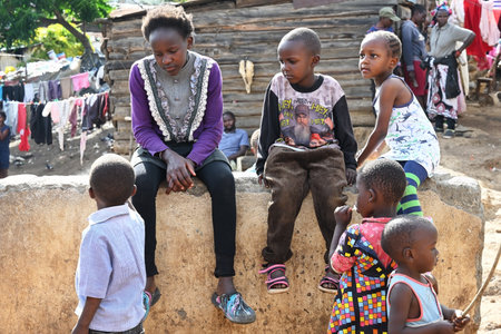 SLUM OF NAIROBI, KENYA - NOVEMBER 18, 2022:  Group of children living in a Nairobi slum. Largest urban slum in Africa. Kenyaのeditorial素材