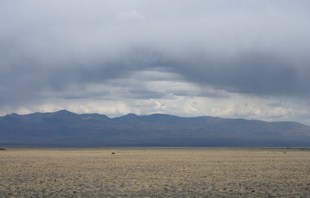 Thunderclouds and rain coming over the steppe in the Altay Mountains, Russia