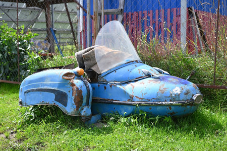 An old abandoned motorcycle sidecar overgrown with grassの写真素材