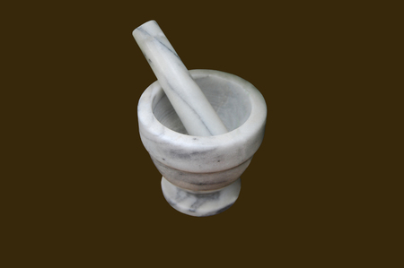Marble mortar with a pestle on a brown backgroundの写真素材