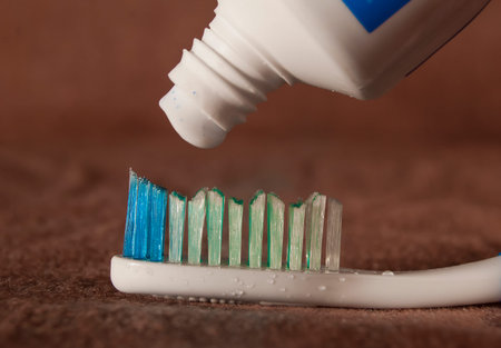 Toothbrush and toothpaste, the process of beginning extrusion close-up.