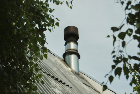 Metal chimney on the roof of the house.の写真素材