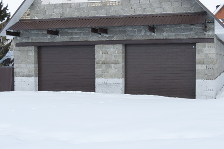 Garage stone with roller shutters in brown color for two cars.の写真素材