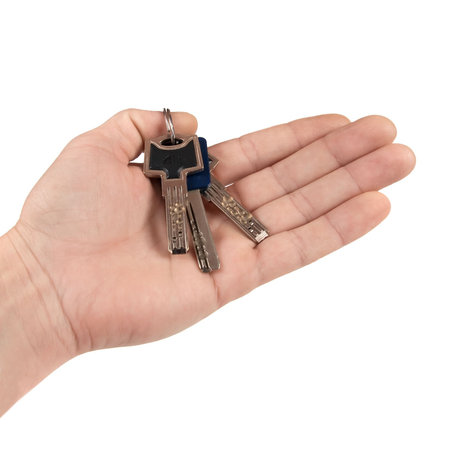 Bunch of keys on hand. Isolated on white background.