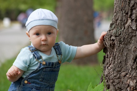 Portrait of a happy little boy in a cap and jeans の写真素材
