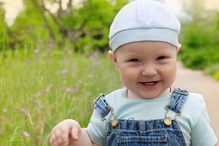 Portrait of a happy little boy in a cap and jeans の写真素材