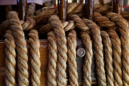 Rope control the sails, tied to a wooden beam の写真素材