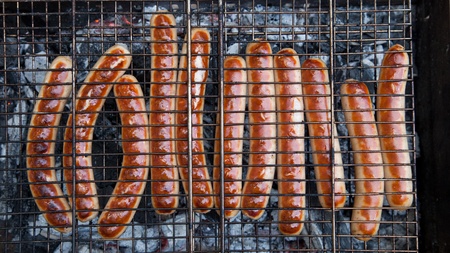 Grilled sausages are roasted on the fireの写真素材