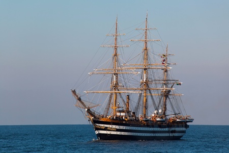 A beautiful three-masted sailboat in the open seaの写真素材