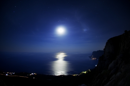Seascape at night. The coastline moonlight and stars in the skyの写真素材