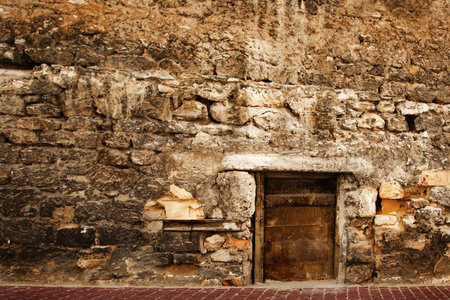 Old small door in the stone wall の写真素材