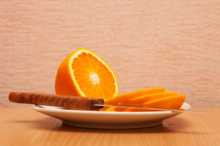 Orange cut with a knife on a plate