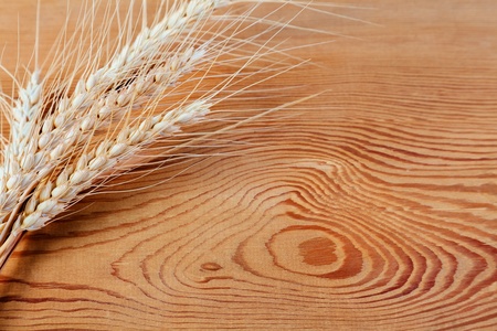 Ears of wheat on a wooden backgroundの写真素材