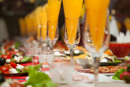 Served for a banquet table  Wine glasses with napkins, glasses and salads  