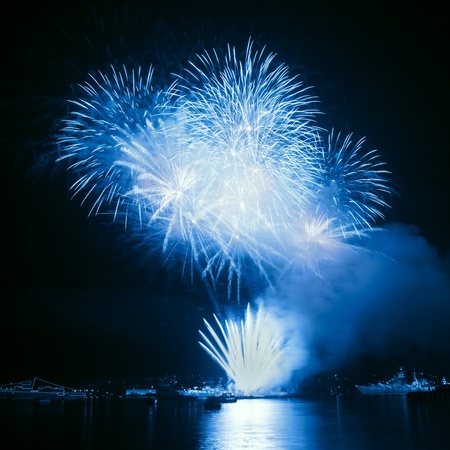 Fireworks in the night sky with reflection on water の写真素材