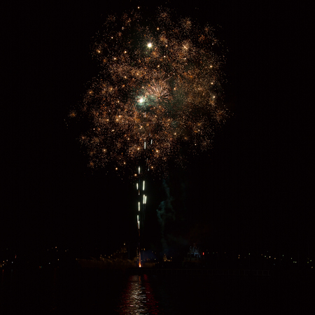 Firework over the water in the night skyの写真素材