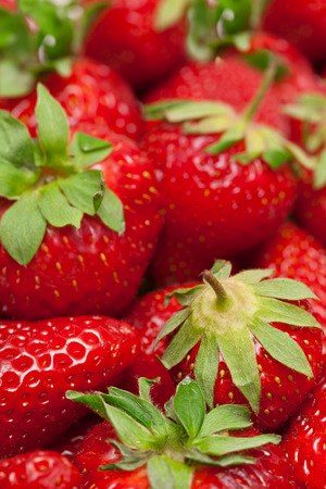 Strawberries with green leaves close-up.の写真素材